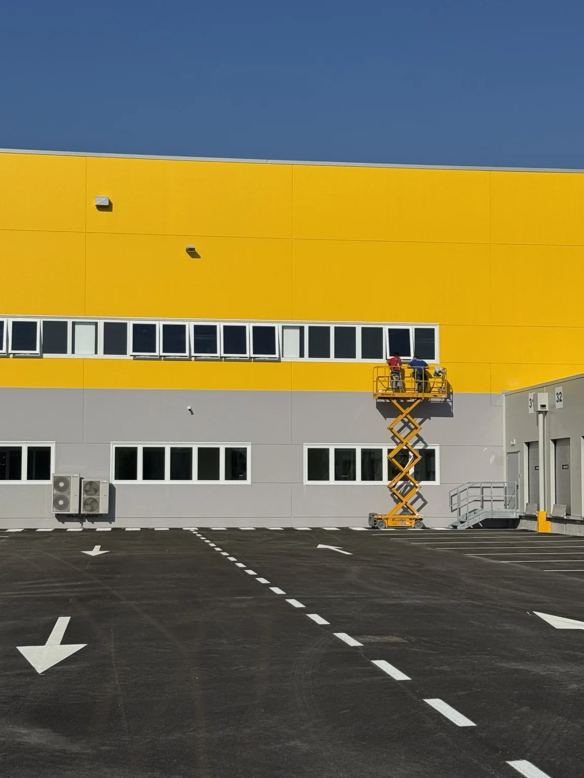 Installazione dei serramenti sulla facciata del polo DHL Express di Dosson di Casier.